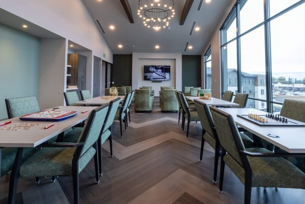 Bright activity room with tables and chairs for games