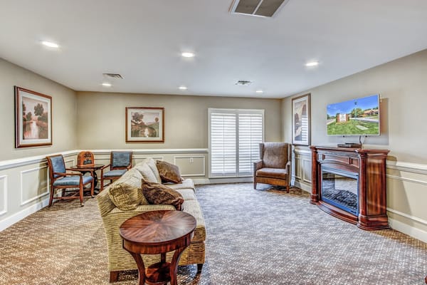 Comfortable living room setting with a sofa, chairs, and a television.