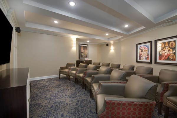Cozy theater room with comfortable seating and framed movie posters