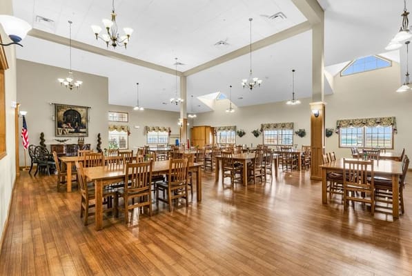 Spacious dining room with wooden tables and chairs