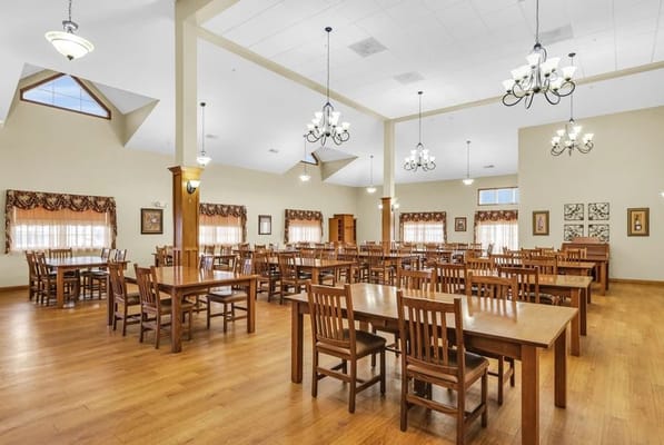 Spacious dining room with wooden tables and chairs