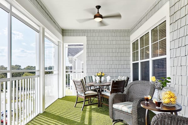 Cozy outdoor balcony with table and chairs