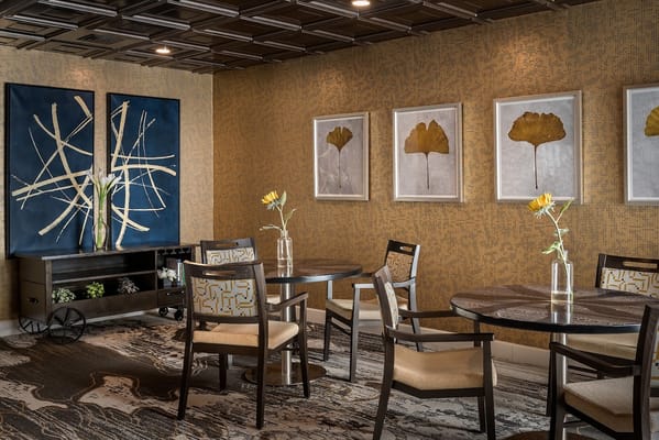 Common area with tables and decorative wall art