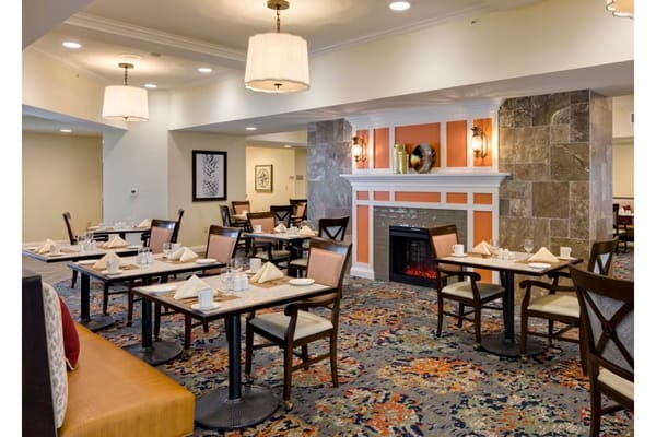 Dining area with tables and chairs set for a meal