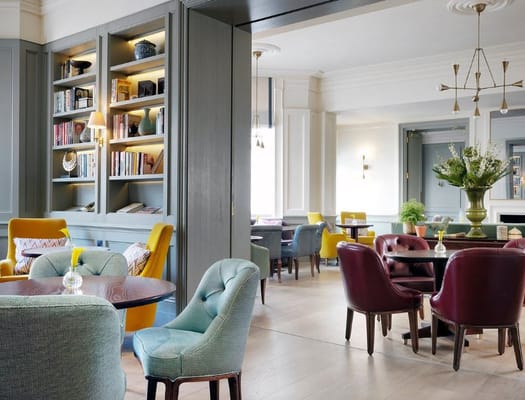 Cozy lounge space with colorful chairs and bookshelves