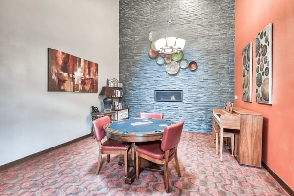 Cozy common area featuring a round table and piano