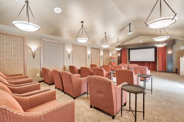 Cozy theater room with seating and a large screen