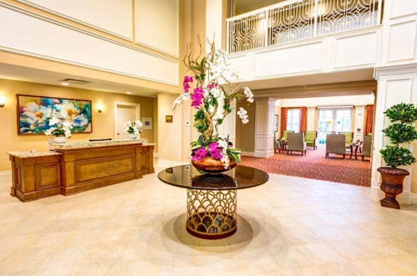 Bright lobby with floral arrangement and reception desk