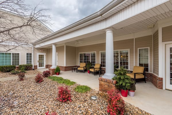 Seating area on the patio with flowers and trees