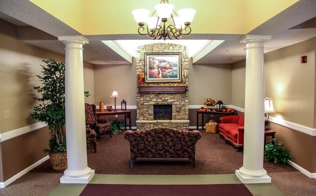 Comfortable seating area with stone fireplace and decorative artwork