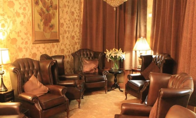 Comfortable leather lounge chairs in a warm, inviting setting