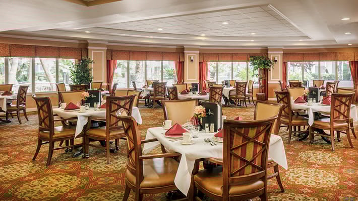 Cozy dining area with tables set for dining