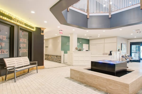 Bright and inviting lobby area with a water feature and seating
