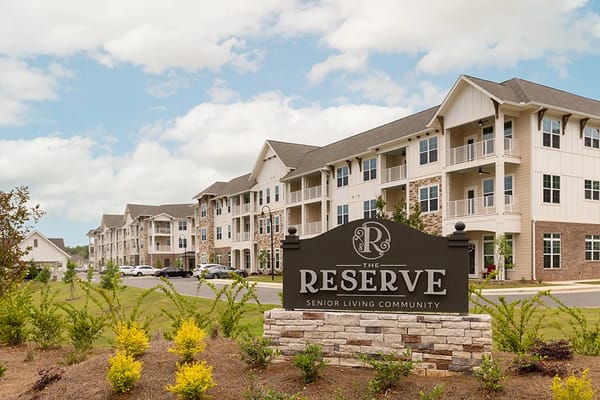 Sign of The Reserve senior living community with building in background