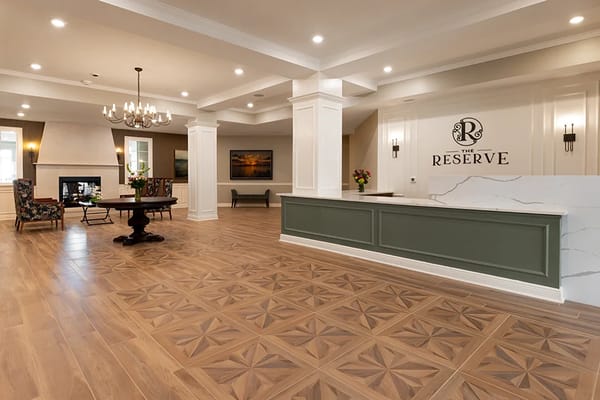 Bright and spacious lobby with a reception desk and seating area