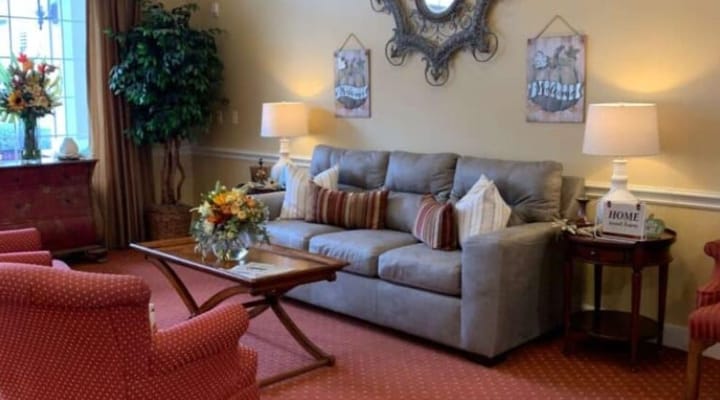 Comfortable living room with a couch, chairs, and decorative elements at The Reserve at Pearland