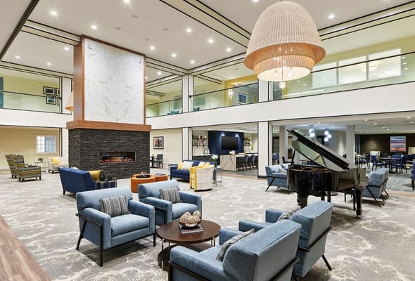 Bright and modern living room with seating and piano