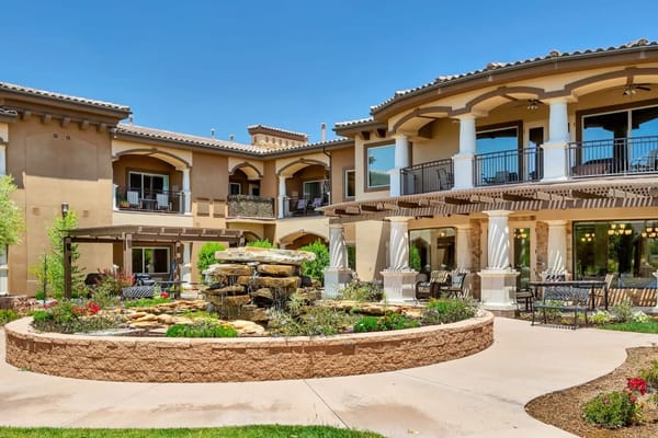 Beautiful courtyard with a fountain and seating area at The Retreat at Sunbrook.