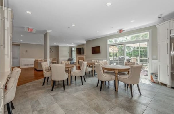 Bright dining area with round tables and chairs.