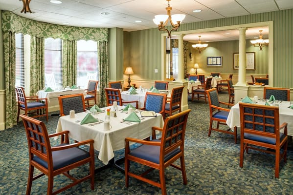 Elegant dining room with tables set for meals