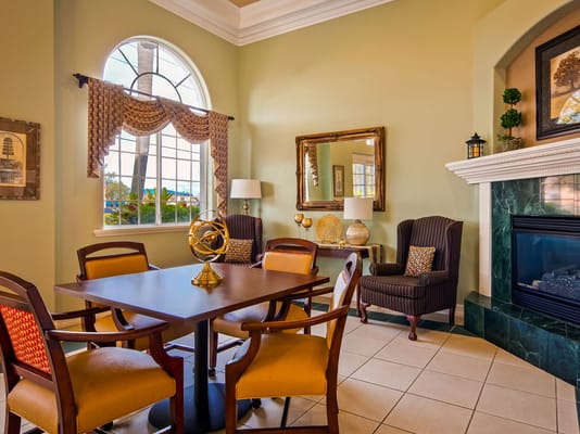 Lounge area with a table and chairs near a fireplace