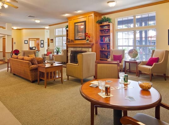 Comfortable lounge seating with a fireplace in a senior living facility