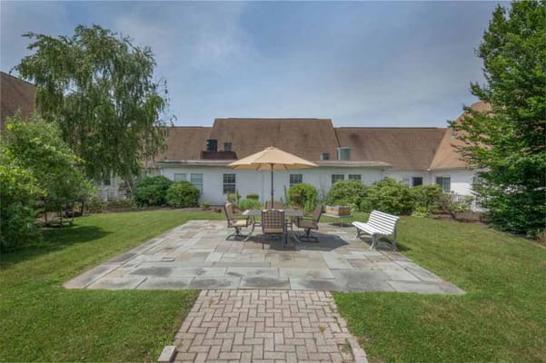 Outdoor patio with seating and umbrella at Tiffany Court