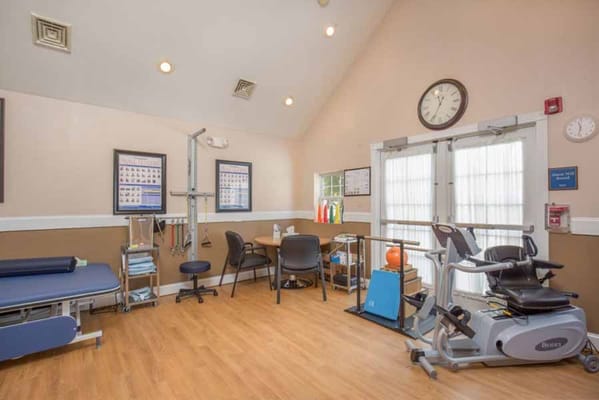 Interior view of the therapy room with exercise equipment.