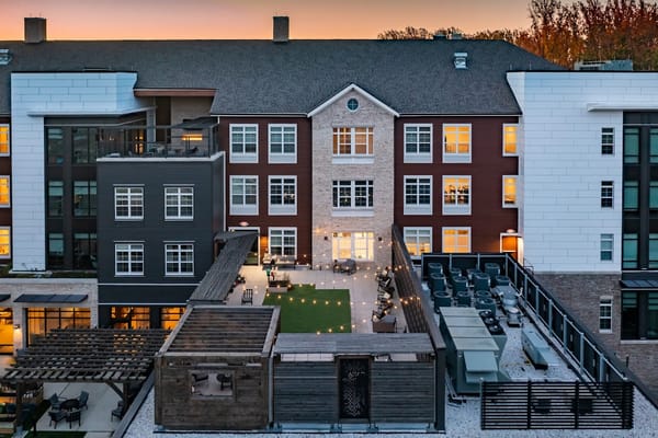 Patio area with seating and greenery at dusk