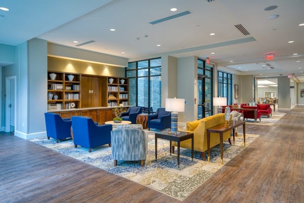 Lounge area with colorful chairs and tables at Tribute at Melford