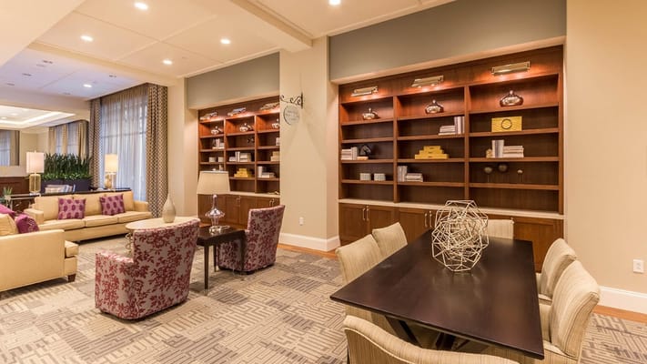 A well-decorated lounge area with comfortable seating and bookshelves.