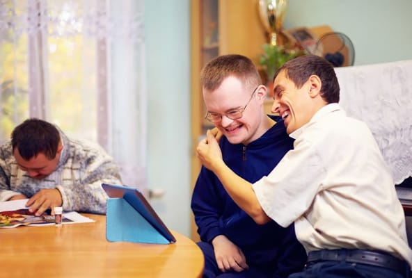 Two residents enjoying an activity together at a table.