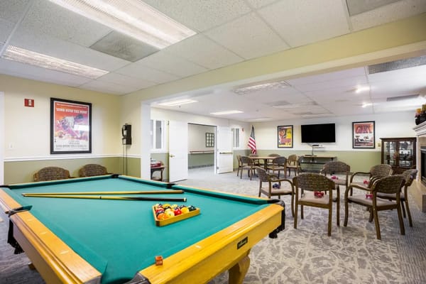 Pool table in the game room with seating area