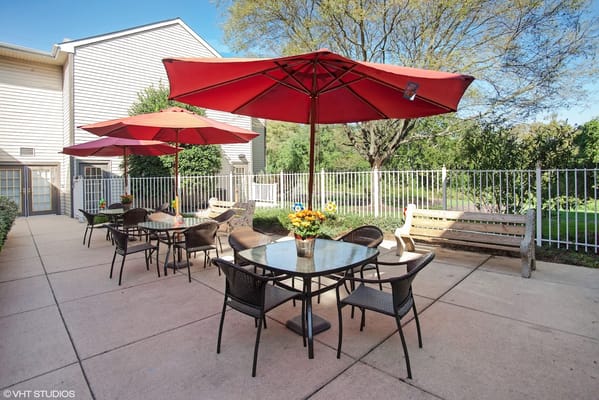 Patio with red umbrellas and table seating