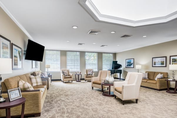 Cozy lounge area with seating and a piano