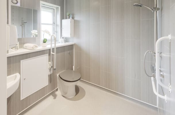 Accessible bathroom with modern fixtures and grab bars.