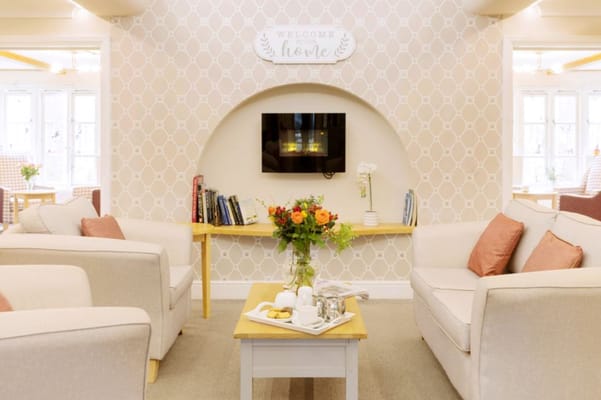 Comfortable living room with seating and a decorative wall.