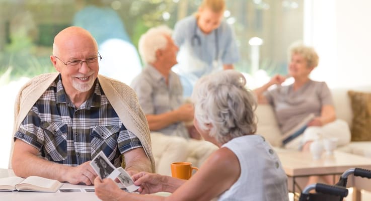 Residents engaging in conversation in a cozy common area