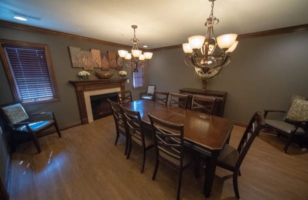 Cozy dining room with a large wooden table and chandelier