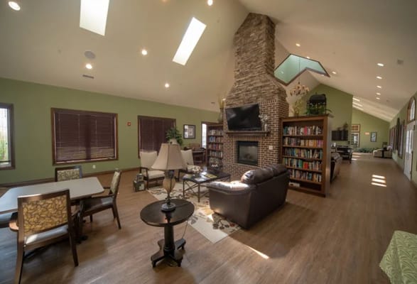 Cozy common area with a fireplace and bookshelves