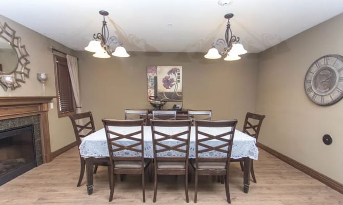 A dining room table set with chairs in a cozy environment