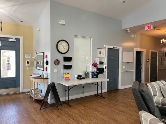 A bright interior of a facility lobby with seating area