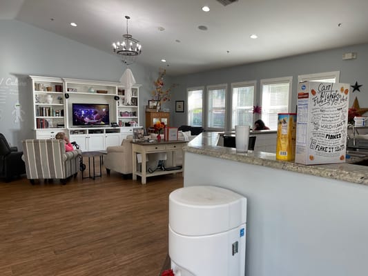 Residents relaxing in a common area with a TV