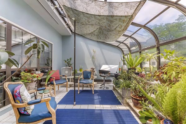 Bright sunroom with plants and seating