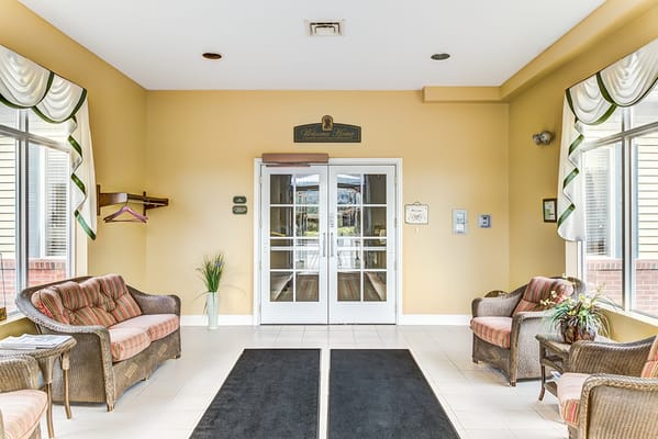 Cozy lobby area with seating and entrance doors at Walden Place