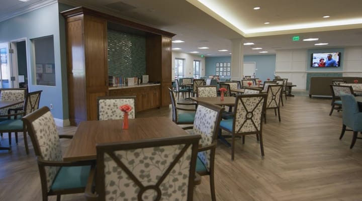 Interior view of a common area with dining tables and chairs