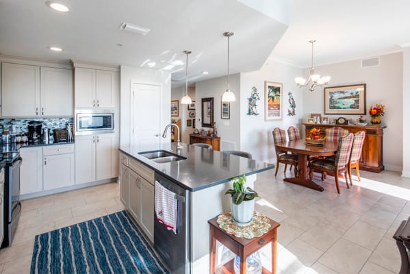 Bright interior common area with dining table and kitchen