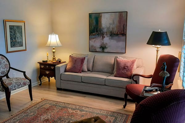 Well-furnished common area with seating and art