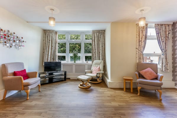 Bright, cozy common area with seating and large windows