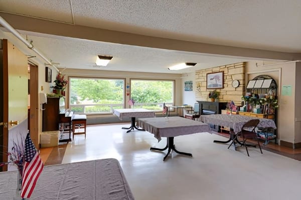 Common area with tables and chairs in natural light